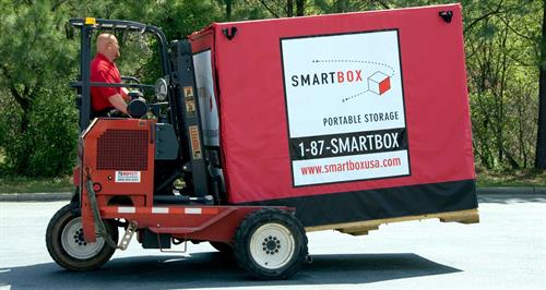 man carrying smartbox on forklift