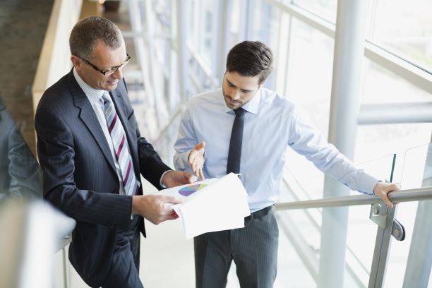 Two men talking about paper