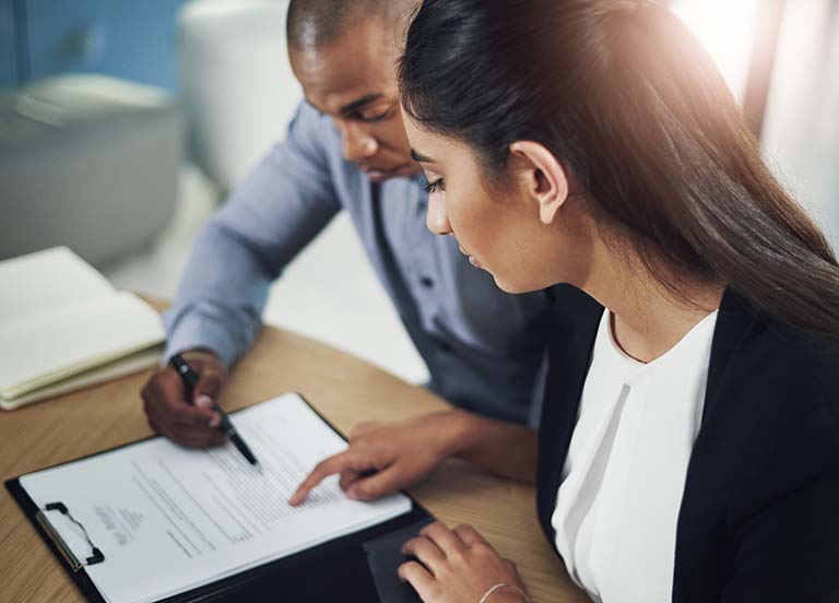 Business people going through paperwork in an office