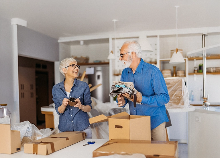 Senior couple sorting out moving boxes