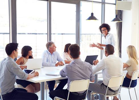 businesswoman presenting to colleagues at a meeting