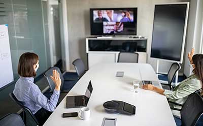 women wearing masks in office on video call