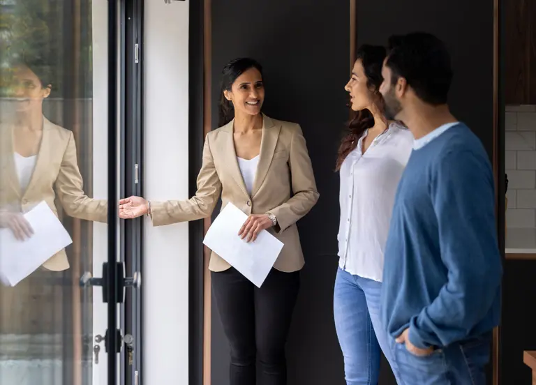 Housing consultant showing a residential property to relocating employees