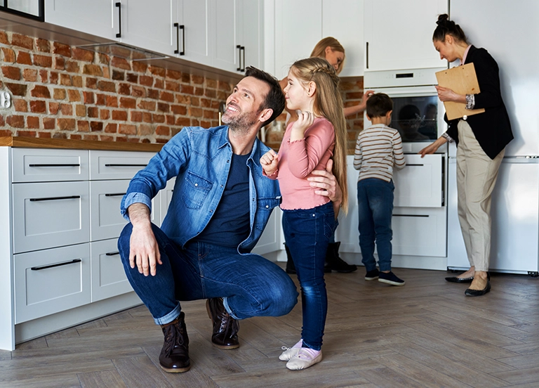 A family gathered in a modern kitchen